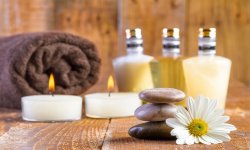 zen basalt stones and spa oil with candles on the wood